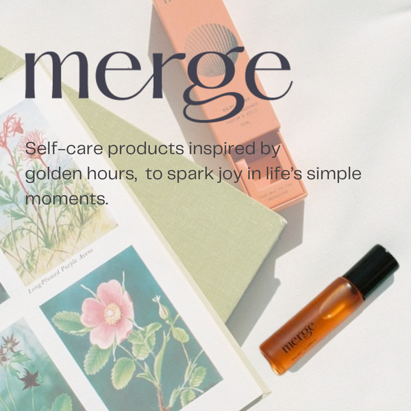 Self-care products inspired by 'golden hours' with a Merge balmy summer roll on bottle and floral cards on a light background.